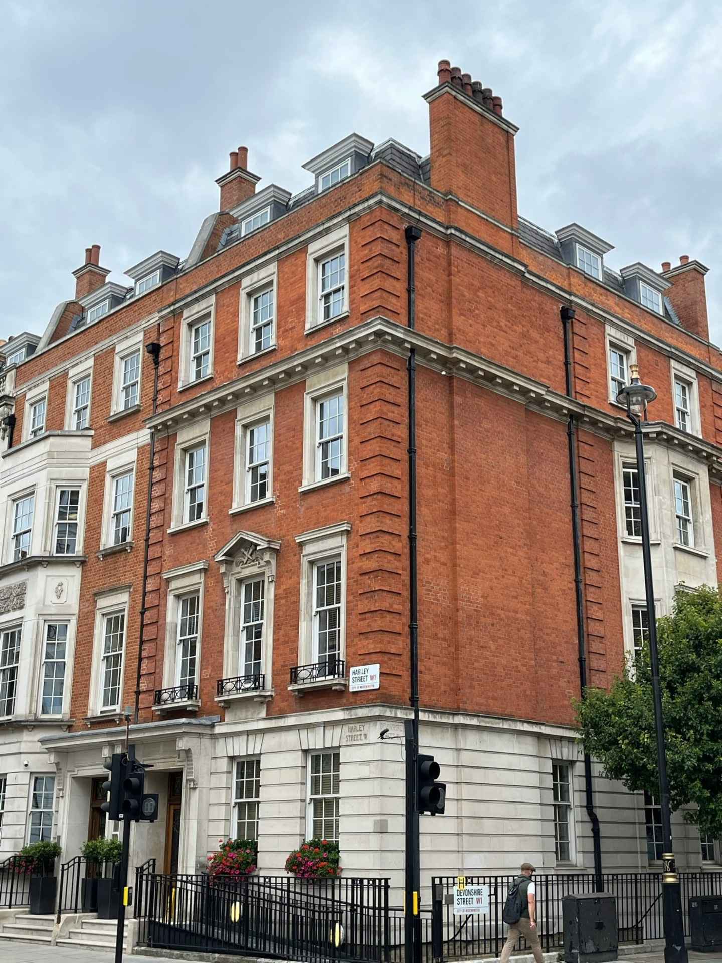 a large brick building with a black fence around it